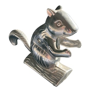 Silver toned Squirrel Nutcracker sitting on a log