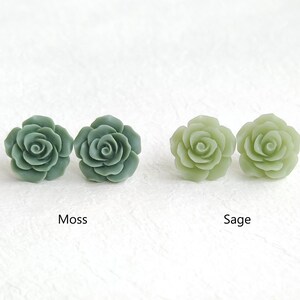 May include: Two pairs of rose-shaped stud earrings. The pair on the left is dark green and labelled Moss, while the pair on the right is light green and labelled Sage. Each earring features a detailed, multi-layered petal design in a matte finish.