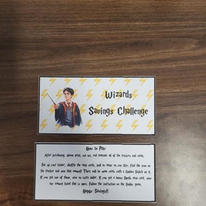 May include: A printable game card with a yellow and white background. The card features a cartoon image of a wizard with a lightning bolt. The text on the card reads "Wizards Savings Challenge" and "How to Play".