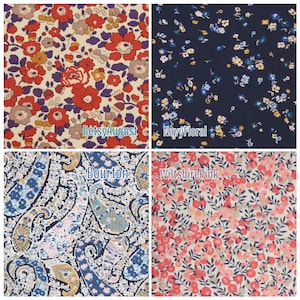 May include: A collage of four fabric swatches with floral and paisley patterns. The swatches include a cream-colored fabric with red flowers, a navy blue fabric with small blue and yellow flowers, a blue paisley fabric, and a pink floral fabric. Text labels identify each fabric.