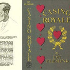 May include: A book cover with a gray background and a red heart design. The title of the book is "Casino Royale" by Ian Fleming.