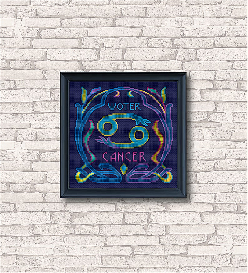 May include: A framed cross-stitch design featuring the astrological sign Cancer, with the words "Water" and "Cancer" in a decorative font. The design is in shades of blue, yellow, green, and pink on a dark blue background.