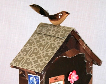 Tiny house chocolate, fine chocolate, found object art, with a bird