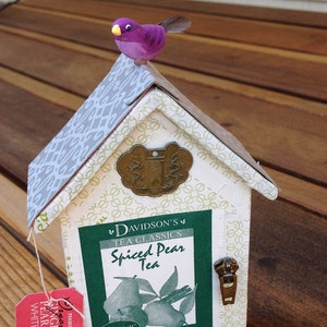 Tiny house, Green Tea, cherry blossoms and Asian coins with a bird
