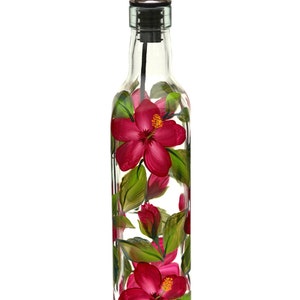 May include: A clear glass bottle with a silver pour spout and a hand-painted design of pink hibiscus flowers and green leaves.