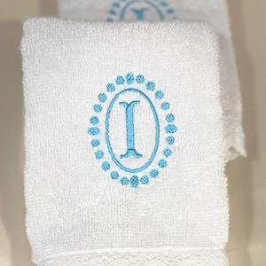 Monogrammed bath towels sets with a lace border. Towel set includes bath towel, hand towel, and wash towel