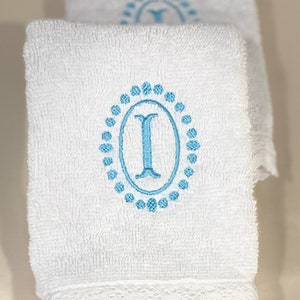 Monogrammed bath towels sets with a lace border. Towel set includes bath towel, hand towel, and wash towel