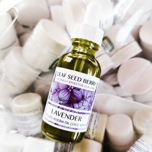 May include: A glass bottle of lavender infused jojoba oil face serum. The bottle is labeled "Leaf Seed Berry Naturally Effective Skin Care Lavender Infused Jojoba Oil | Face Serum".