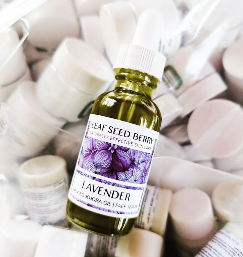 May include: A glass bottle of lavender infused jojoba oil face serum. The bottle is labeled "Leaf Seed Berry Naturally Effective Skin Care Lavender Infused Jojoba Oil | Face Serum".