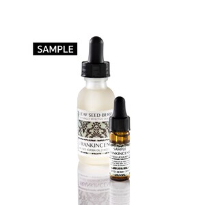 May include: Two glass bottles with dropper tops, one clear and one amber. The clear bottle is labeled "Leaf Seed Berry Naturally Effective Skin Frankincense Infused Jojoba Oil | Face". The amber bottle is labeled "Sample Frankincense Infused Jojoba Oil | Face 5 drops of oil onto clean skin, only onto skin. Add 1-2 drops to your favorite face oil infused with Leaf Seed Berry Skin"