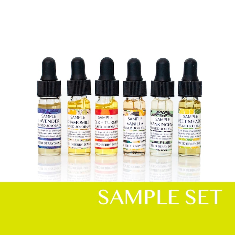 May include: A set of six small glass bottles with dropper tops, each containing a different essential oil blend. The bottles are labeled with the names of the blends: Lavender, Chamomile, Ginger + Turmeric, Vanilla, Frankincense, and Sweet Meadow. The bottles are arranged in a row on a white surface. The text "SAMPLE SET" is printed in yellow below the bottles.