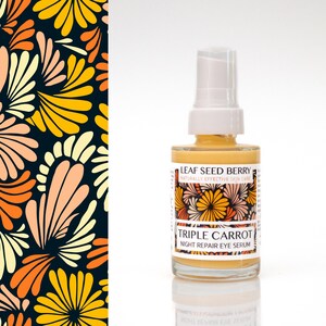 May include: A clear glass bottle of Triple Carrot Night Repair Eye Serum with a white pump top. The label features floral designs and the text "Leaf Seed Berry". The background includes a dark blue floral pattern with yellow, orange, and peach colors.