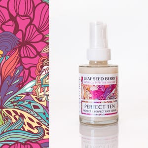 May include: A clear glass bottle with a white pump top, containing a beige liquid. The label reads "LEAF SEED BERRY" and "PERFECT TEN". The background features a colorful floral pattern in pink, orange, and teal.