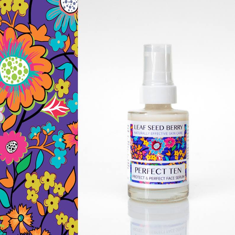 May include: A clear glass bottle with a white pump top and a white label. The label says "Leaf Seed Berry Naturally Effective Skin Care" and "Perfect Ten Protect & Perfect Face Serum". The bottle is sitting on a white surface.