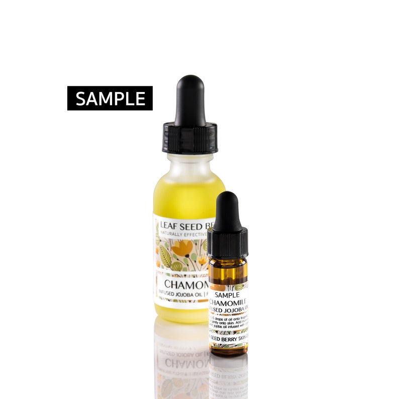 May include: Two glass bottles with droppers, one larger than the other. Both bottles contain a yellow liquid and have labels with the text "SAMPLE LEAF SEED BEAUTY NATURALLY EFFECTIVE CHAMOMILE INFUSED JOJOBA OIL 1 FL OZ" and "SAMPLE CHAMOMILE INFUSED JOJOBA OIL 1 FL OZ"
