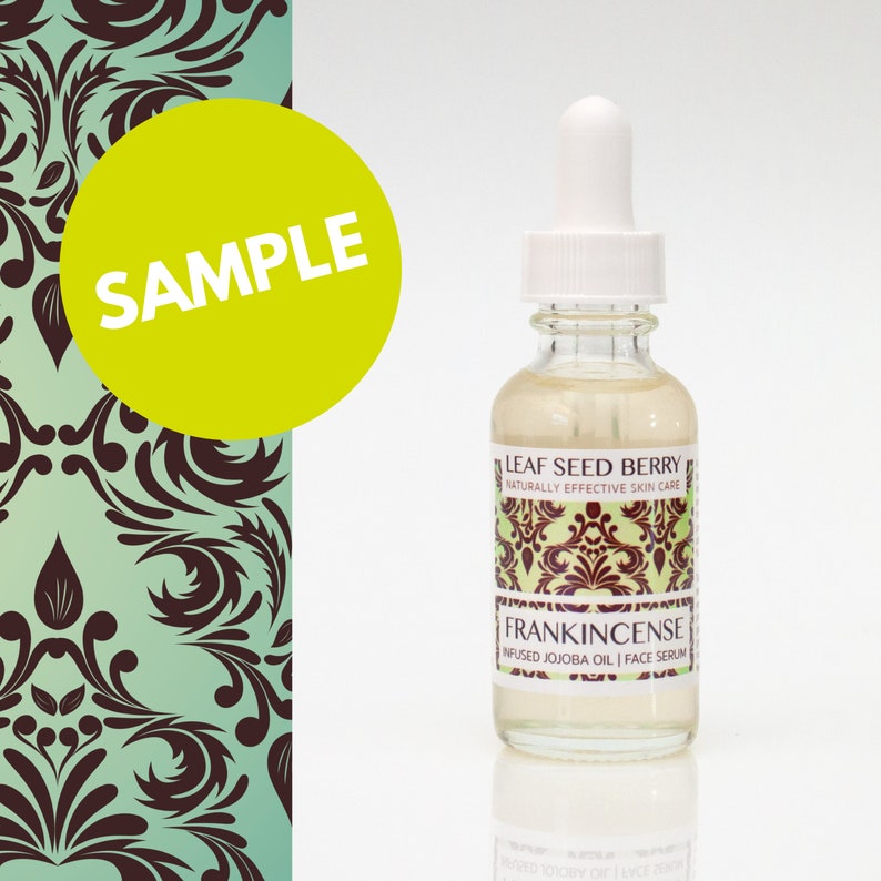 May include: A clear glass bottle with a dropper top filled with a light yellow liquid. The bottle has a label that reads "Leaf Seed Berry Naturally Effective Skin Care Frankincense Infused Jojoba Oil | Face Serum".