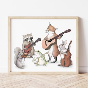 May include: A framed art print featuring a group of woodland animals playing musical instruments. A squirrel plays a violin, a raccoon plays a guitar, a frog plays a banjo, a fox plays an acoustic guitar, and a rabbit plays a double bass.