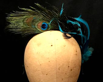 Kentucky Derby fascinator "Emme" created from shimmering Peacock feathers.  Lovely Wedding headpiece, tea party fascinator or spring soiree.