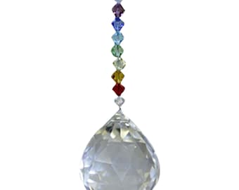 May include: A clear crystal ball with a rainbow of crystal beads hanging from it. The beads are in the order of the chakras: violet, indigo, blue, green, yellow, orange, and red.