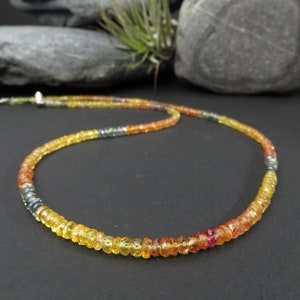 colorful faceted sapphire gemstone necklace in orange, yellow, blue, red with sterling silver clasp