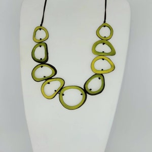 Avacado green tagua nut, open beads. A light and bold natural black necklace. Tagua beads in a simple statement necklace. Green necklace.
