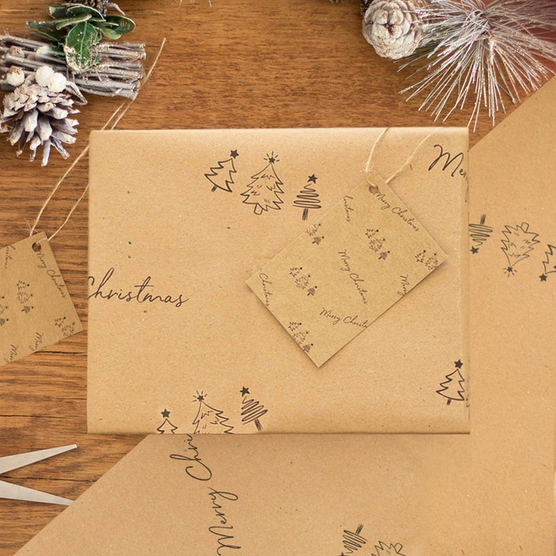 May include: Brown paper gift wrap with a repeating pattern of small Christmas trees and stars. The paper is wrapped around a box with a tag that says "Merry Christmas".