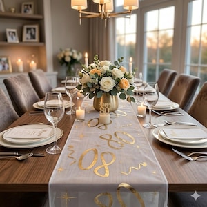 May include: A decorated dining table set for a special occasion. It features a floral arrangement in a gold vase, candles, and place settings. A sheer table runner with gold '80' lettering and star accents adds a celebratory feel. The room is lit by a chandelier and natural light.
