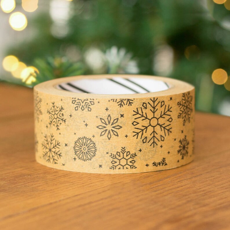 May include: A roll of brown packing tape with a snowflake pattern printed on it.