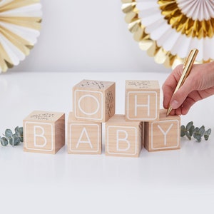 May include: Wooden blocks spelling "OH BABY" with white lettering. Each block has a blank surface for guests to write messages.