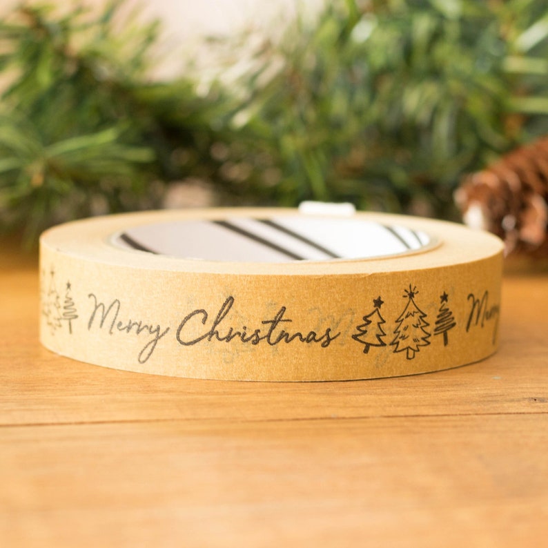 May include: Brown paper tape with a black print of Christmas trees and the text "Merry Christmas".
