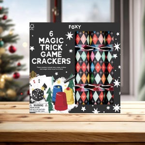 May include: A box of six "Magic Trick Game Crackers" with a black background and white star accents. The crackers have a colorful diamond pattern. The box includes images of playing cards, dice, and cups.