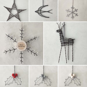 May include: Nine different wire ornaments for Christmas. The ornaments include a star, a bird, a snowflake, a reindeer, and three holly sprigs with red, grey, and white berries.