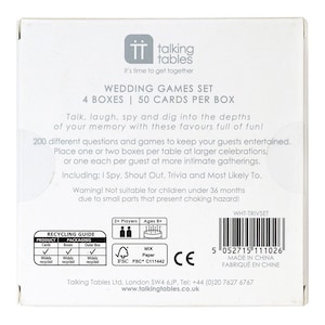May include: A white box with a wedding games set. The box has a picture of two people and a cake on it. The text on the box says "Wedding Games Set" and "4 Boxes | 50 Cards Per Box". The box also has a recycling guide on it.