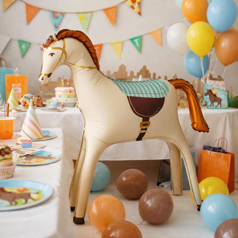 May include: An inflatable horse balloon in cream, brown, and gold, with a striped saddle. The horse is set up for a party, surrounded by balloons and party supplies. The horse is a fun decoration for a birthday party or other celebration.