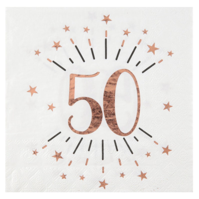 May include: White paper napkins with a rose gold 50 surrounded by a burst of black lines and rose gold stars.