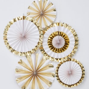 May include: Five white and gold paper fans with scalloped edges. The fans are folded in a circular shape and have a gold glitter finish.