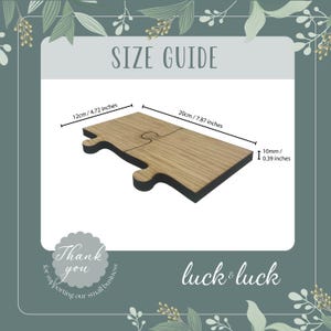 May include: Two wooden puzzle pieces that fit together to form a heart shape. The pieces are 7.87 inches long and 4.72 inches wide. The pieces are 0.39 inches thick. The text "luck & luck" is printed below the puzzle pieces.