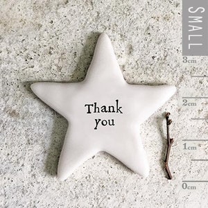 May include: White ceramic star with the words "Thank You" written in black. The star is approximately 7.5 cm wide.