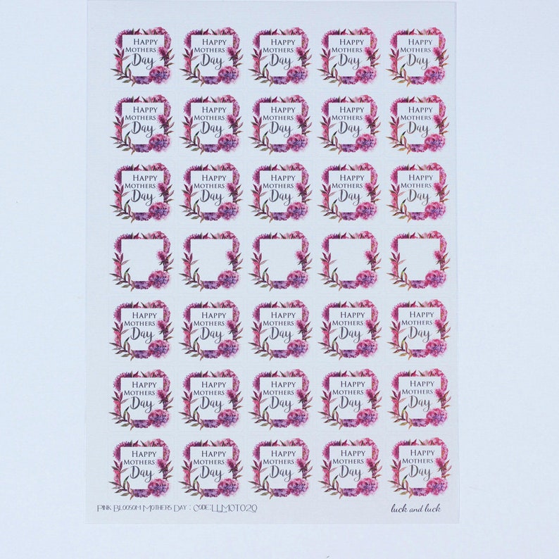 May include: A sheet of 25 stickers featuring a floral wreath design with the text "Happy Mothers Day" in a gray font. The stickers are printed on clear, glossy paper.