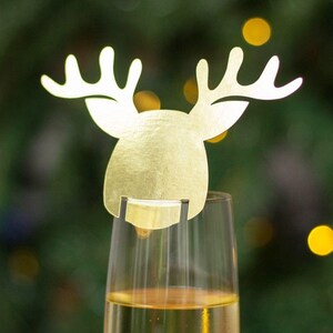 May include: Gold reindeer shaped glass charm for a champagne flute or wine glass.