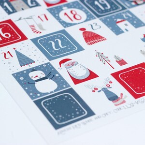 May include: A blue and red Christmas advent calendar with illustrations of a snowman, Santa Claus, a reindeer, and a Christmas tree. The numbers 16, 17, 18, 19, 21, 22, and 23 are visible.