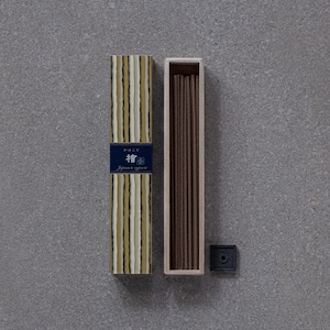 May include: A box of Japanese incense sticks with a striped design and the text "Hoky" and "Japanese incense" on the front. The box is open and the incense sticks are visible inside. There is a small black incense holder next to the box.