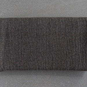 May include: A dark gray knitted fabric with a textured surface.