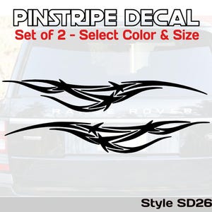 May include: Black pinstripe decal set of two with a tribal design. The decals are displayed on the rear window of a vehicle. The text at the top reads "PINSTRIPE DECAL" and "Set of 2 - Select Color & Size". The style is SD26.