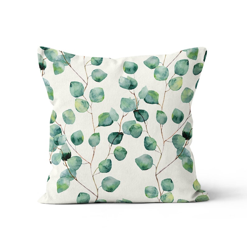 May include: A white pillow with a green watercolor eucalyptus leaf pattern.