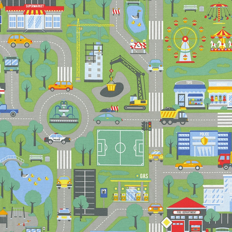 May include: A colourful illustration of a city scene with buildings, cars, trees, and a park. The illustration includes a supermarket, a petrol station, a police station, a fire station, a toy shop, a playground, and a football pitch. The illustration is on a green background.