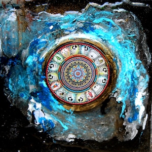 May include: A circular mandala design with intricate details in shades of blue, red, and gold, surrounded by a turquoise blue and white paint splatter effect.