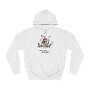 May include: White hooded sweatshirt featuring a pirate ship graphic with a skull and crossbones. The ship sails on the water, and the text "DEAD MEN TELL NO TALES" is below the image. The sweatshirt has a front pocket and a drawstring hood.