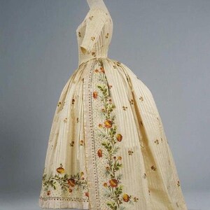May include: A white dress with a floral print and a striped pattern. The dress has a fitted bodice and a full skirt.