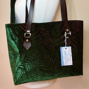 A hand printed two tone fern design green velvet tote bag with leather handles